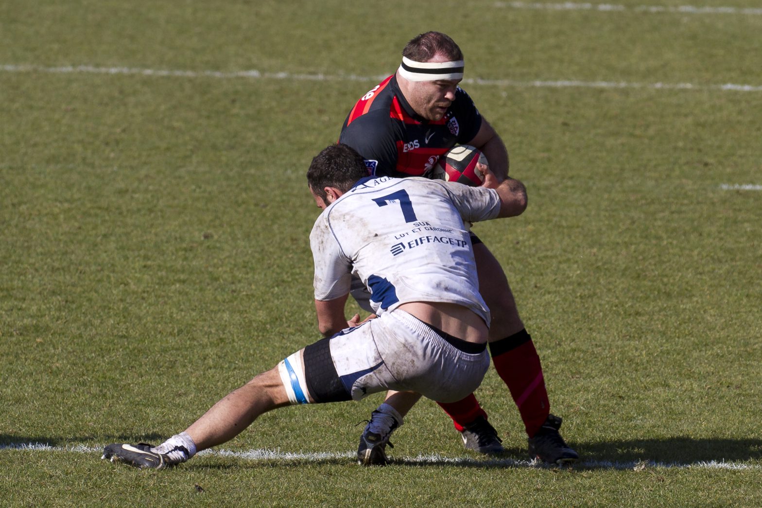Rugby player making a tackle in open field play